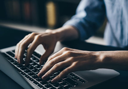 Bildausschnitt mit Hände auf Computertastatur